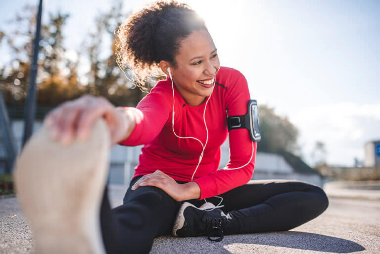 athletic woman stretching her legs